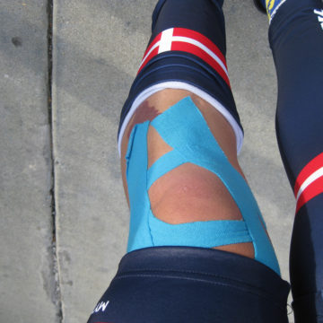 athlete wrapped knee with kinesio tape