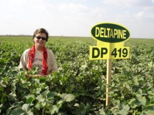 sign in a cotton field with farmer